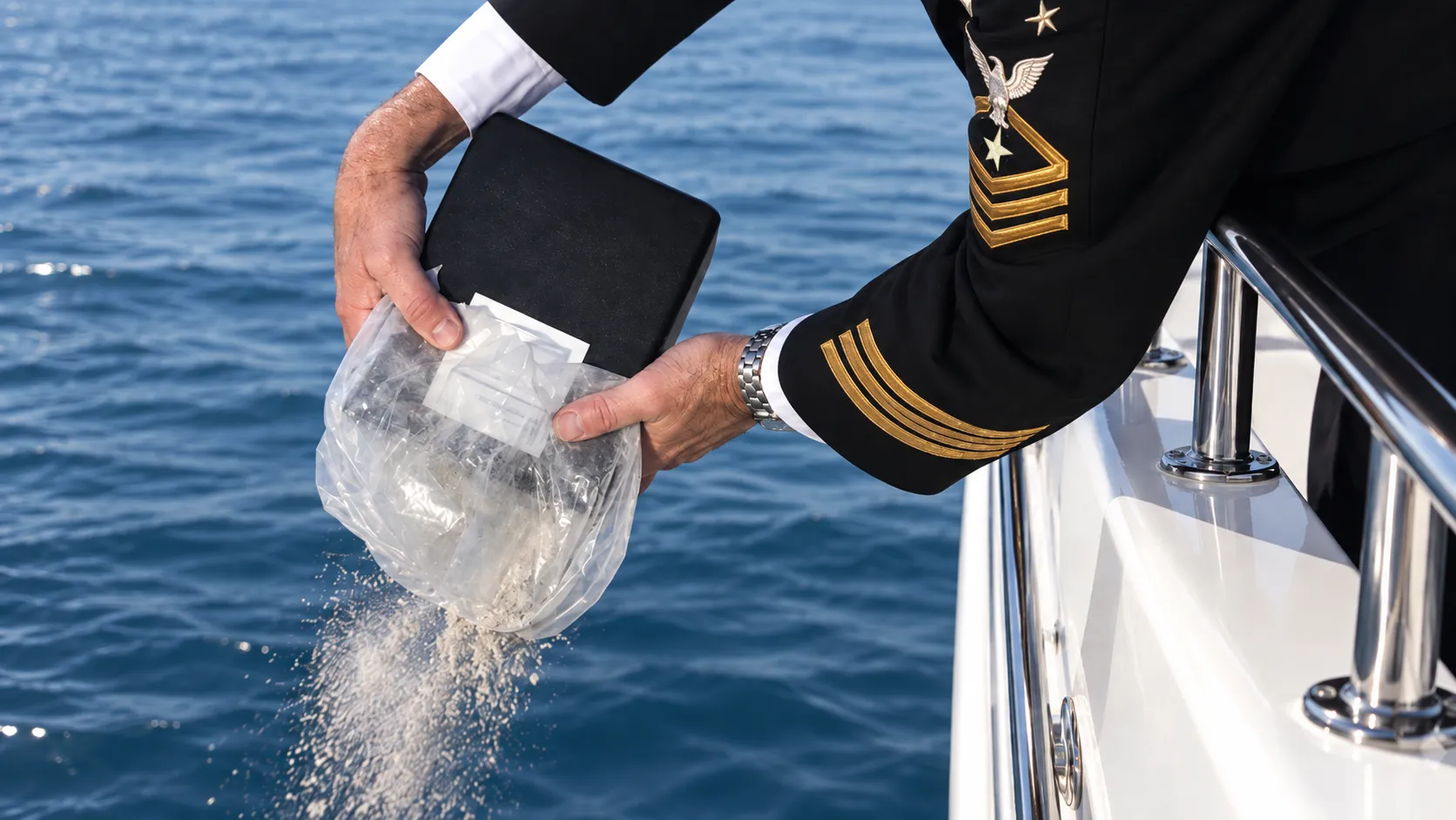 U.S. Coast Guard Master Chief Petty Officer committing cremated remains at sea